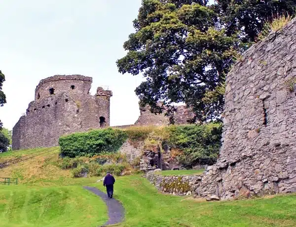 Man walking up the path to the Dundrum Castle, Co. Down, Ireland