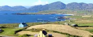 Looking out on the houses, hills and coastline of the beara peninsula in Ireland on the wild atlantic way.