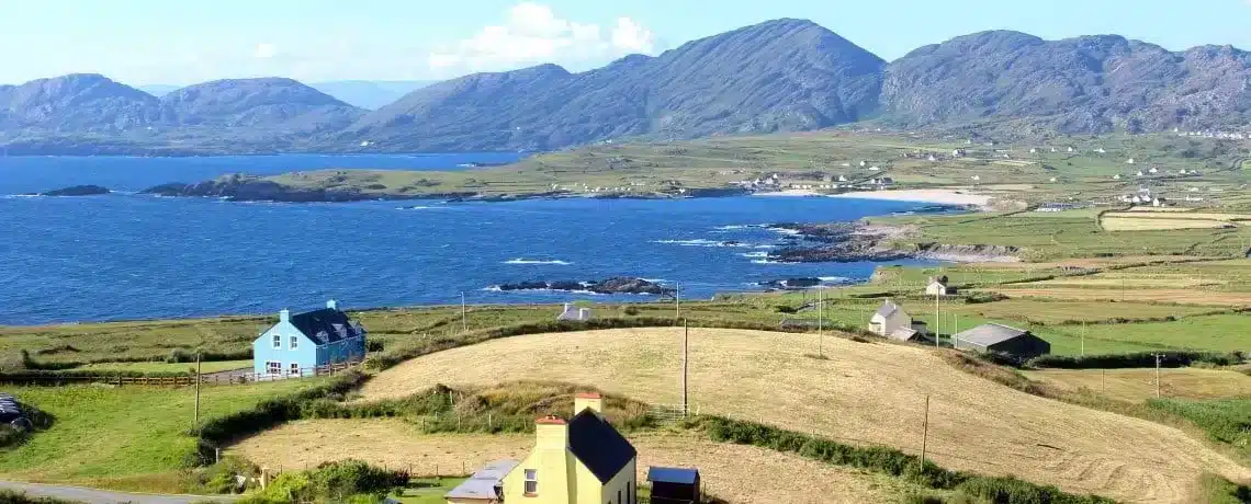 Looking out on the houses, hills and coastline of the beara peninsula in Ireland on the wild atlantic way.