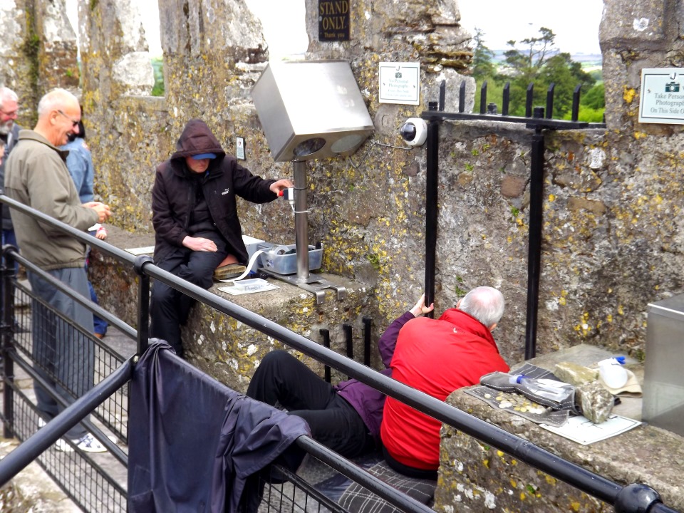 Kissing the Blarney Stone at the top of Blarney Castle.