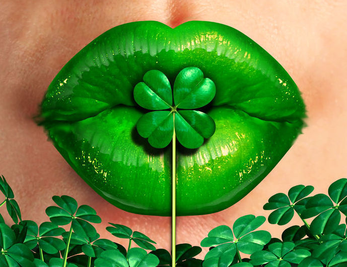 34979317 - spring kiss as emerald green lips kissing a four leaf shamrock clover as a st.patrick