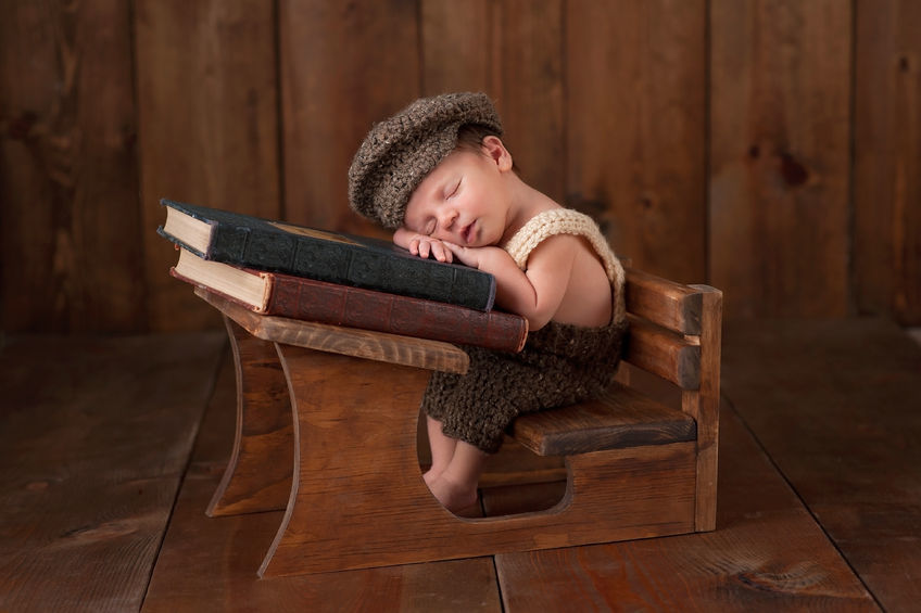 School baby sleeping A baby asleep at a tiny school desk.