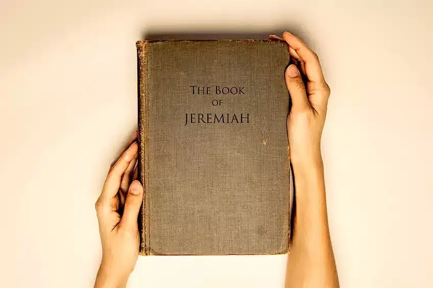 Vintage tone of hands hold the book bible of jeremiah