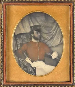 Old portrait of an Irish soldier, part of the 99th Regiment of Foot sitting in an armchair